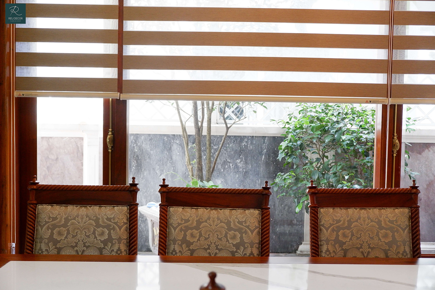 Cửa số phòng ăn được sử rèm cầu vồng có màu cam gỗ tương đồng với bộ bàn ghế, tạo cảm giác gần gũi